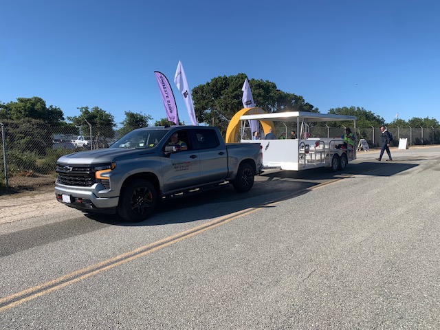 MBV truck towing ADA shuttle trailer at airshow
