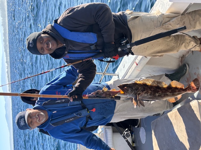 Two veterans proudly showing rockfish catch
