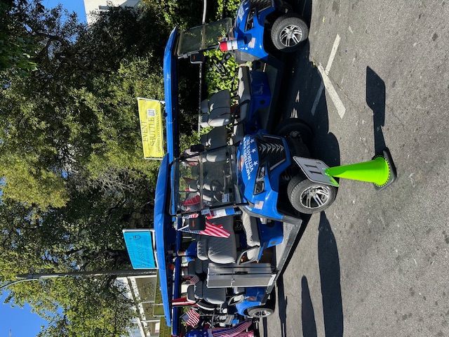 MBV blue shuttle parked with event shuttle signage