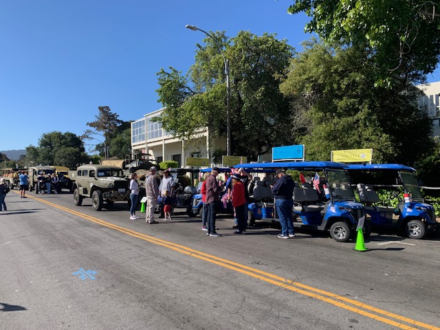 MBV shuttles lined up alongside military vehicles at parade
