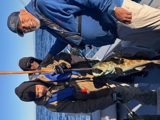Veterans holding lingcod catch on Monterey Bay fishing trip